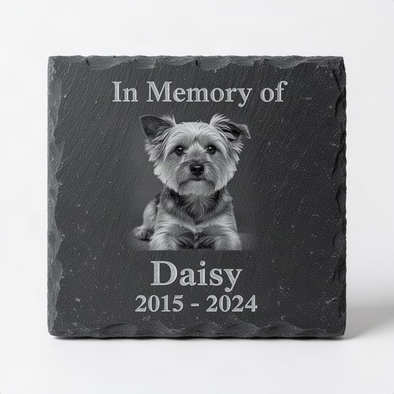 Dark grey slate tile with laser-engraved grayscale portrait of a small dog, name, dates, and In Memory of text